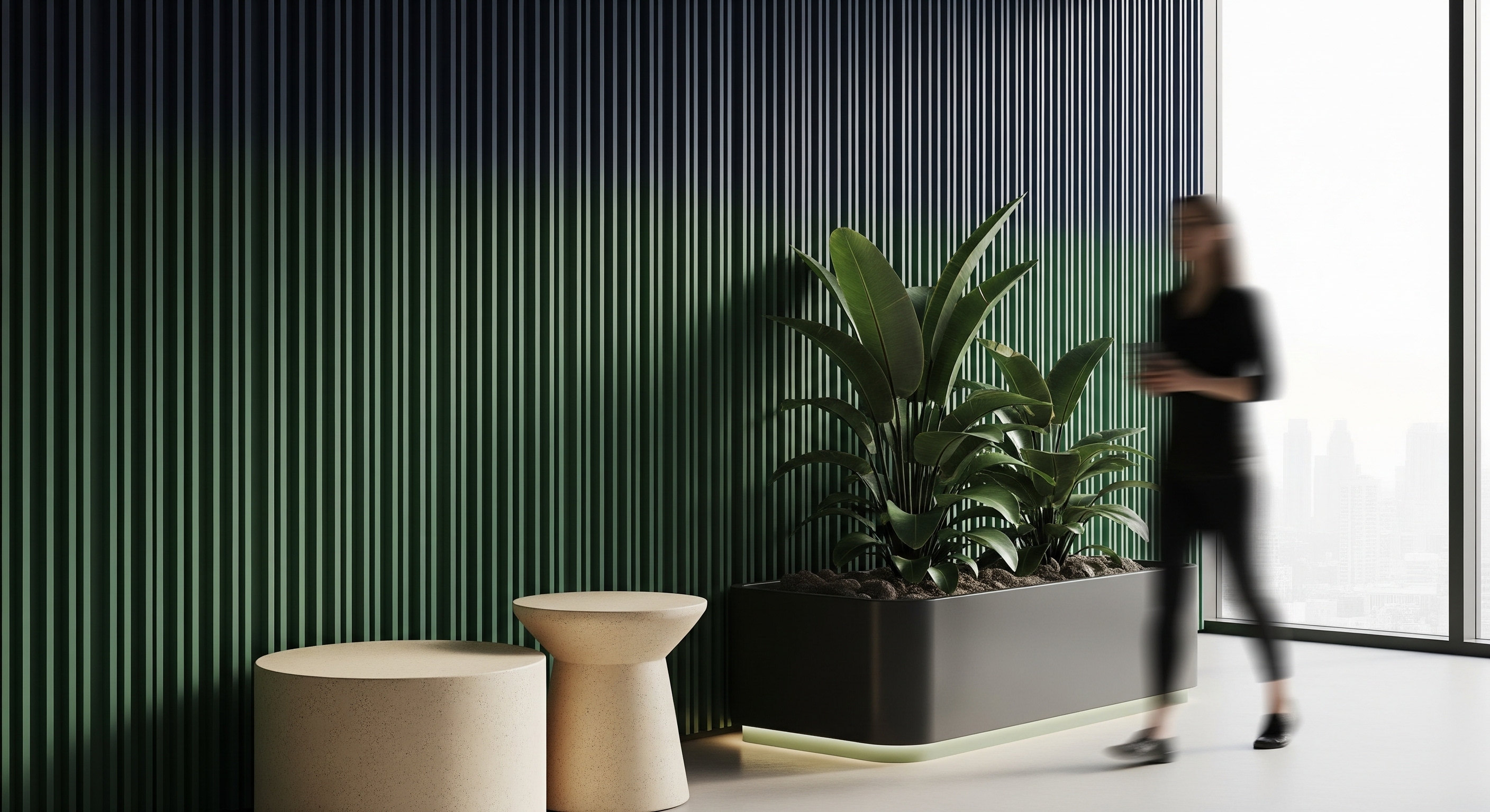 Office lobby with a green fluted wall, a planted palm, wooden stools and a person walking past