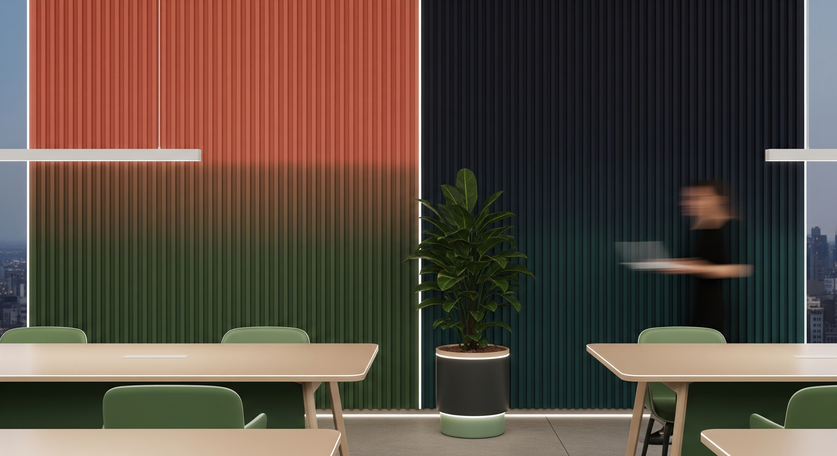 Office canteen with a fluted wall shifting from coral to green, green chairs and a large potted plant at the centre